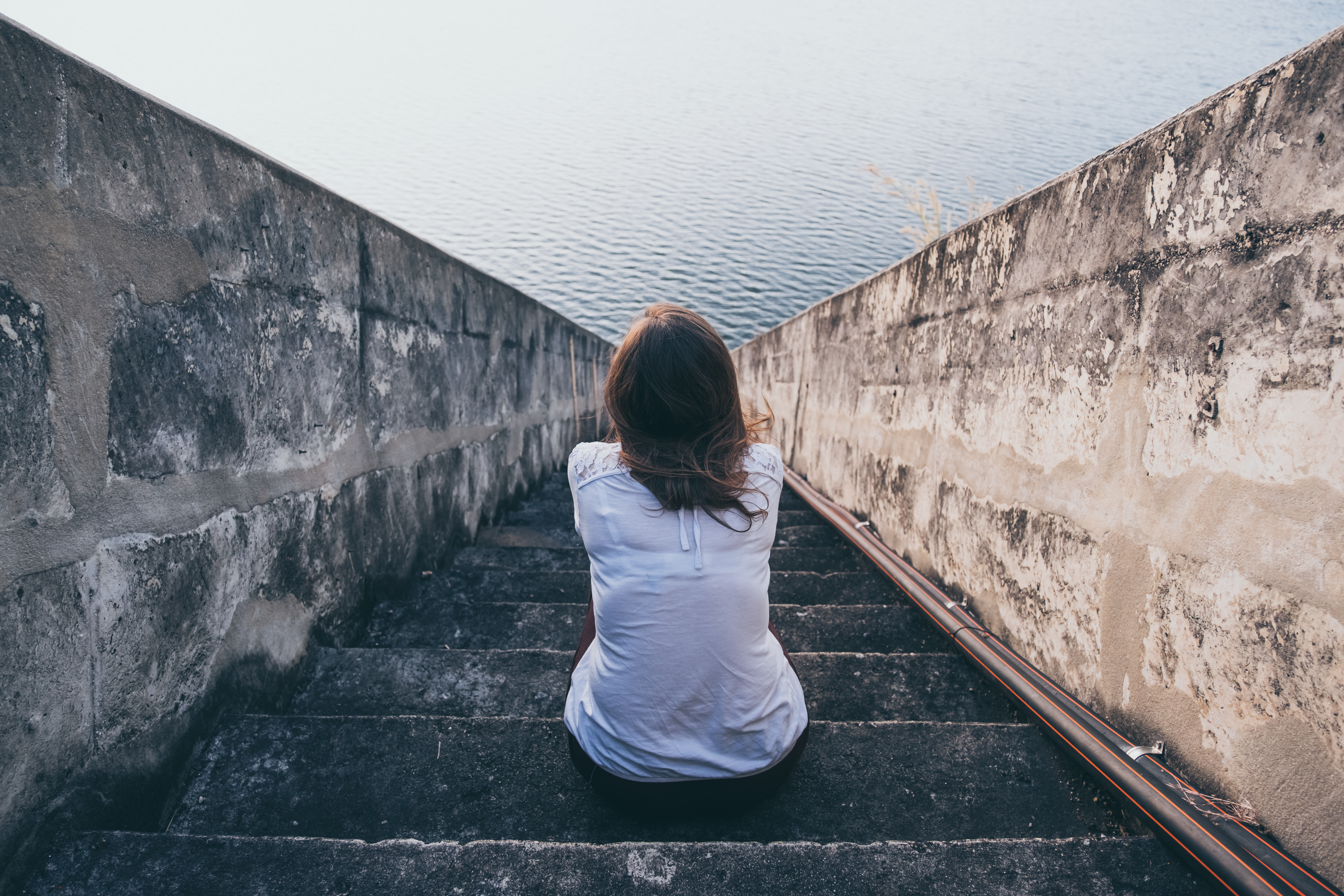 Woman on stairs sad