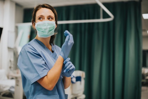 A nurse using safety procedures
