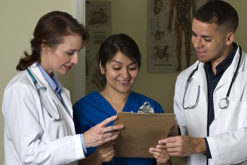 Healthcare workers conducting a training and holding a clipboard