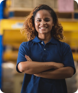 Engaged warehouse worker smiling