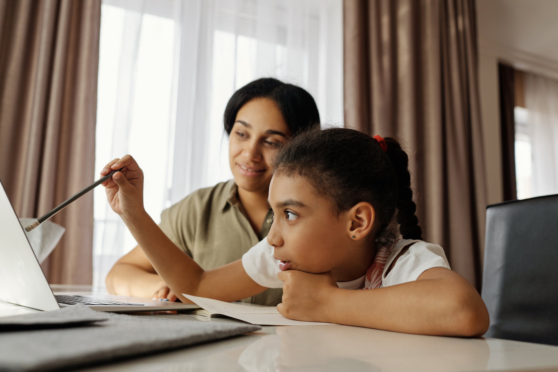 Parent and daughter doing online class