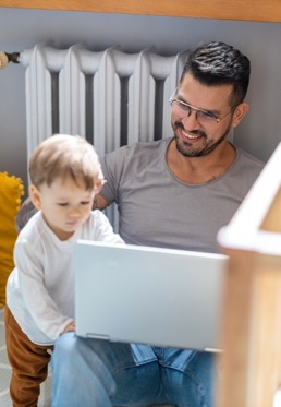 Remote worker dad with their son working from home.